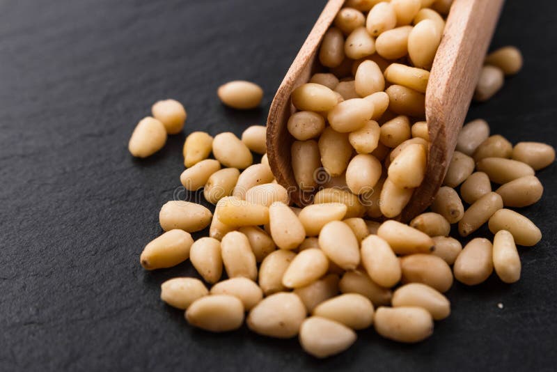 Peeled pine nuts on a rustic background stock photos