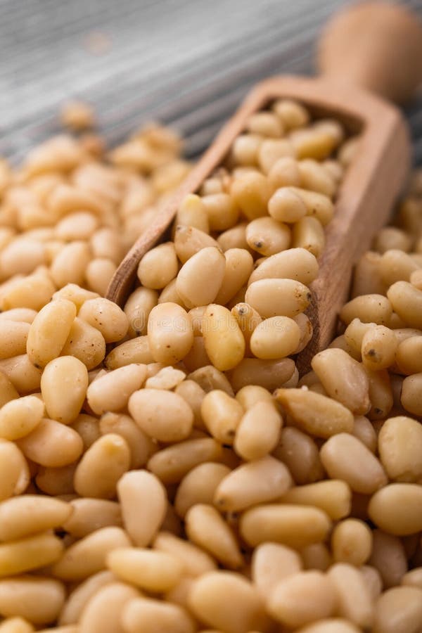 Peeled pine nuts on a rustic background royalty free stock photography