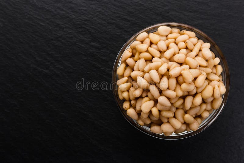 Peeled pine nuts on a rustic background royalty free stock photos