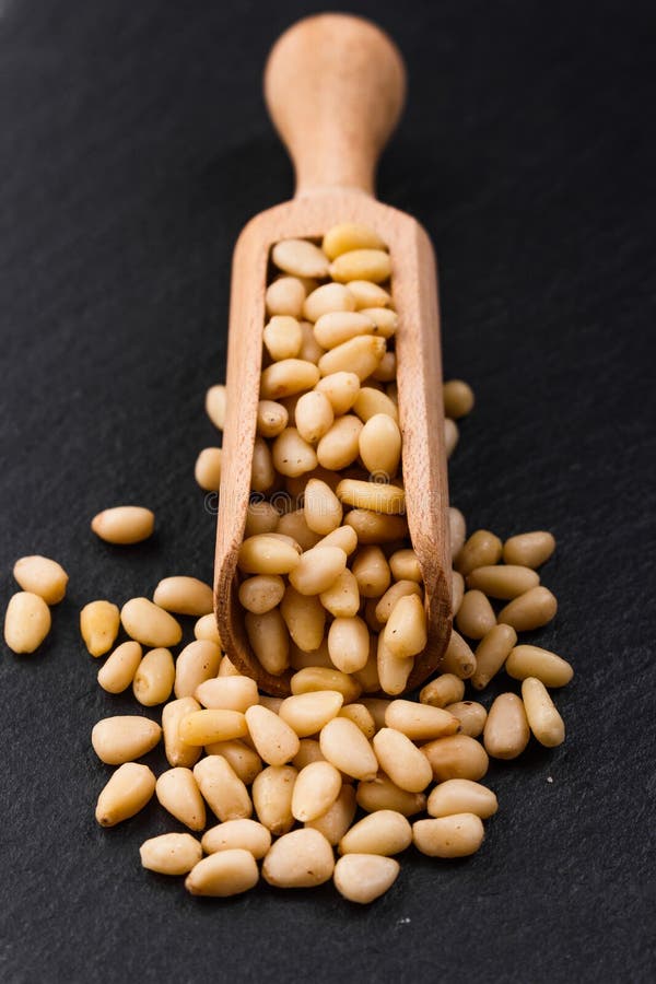 Peeled pine nuts on a rustic background royalty free stock image