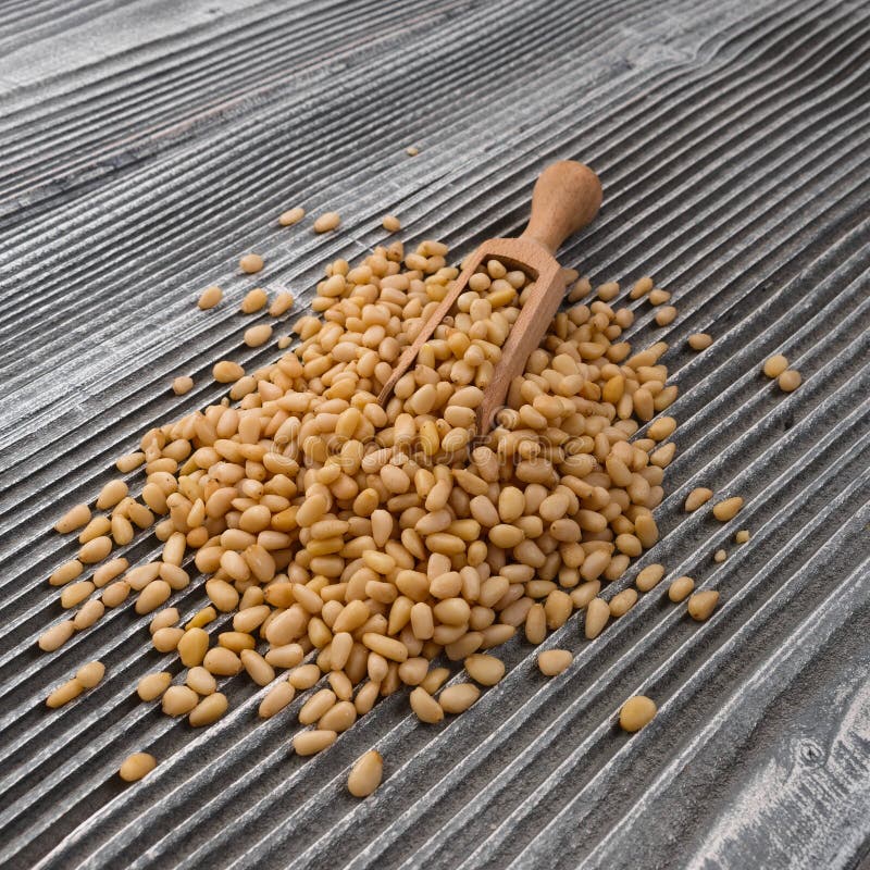 Peeled pine nuts on a rustic background stock images