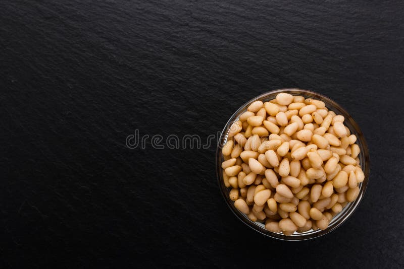 Peeled pine nuts on a rustic background royalty free stock photos
