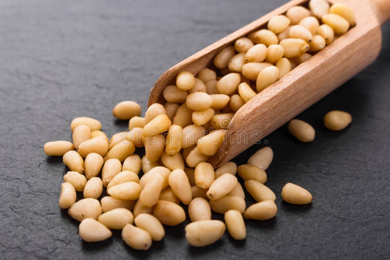 Peeled pine nuts on a rustic background royalty free stock photo