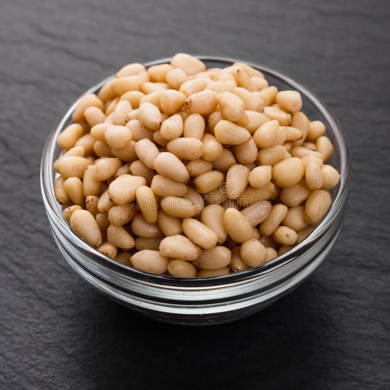 Peeled pine nuts on a rustic background royalty free stock image