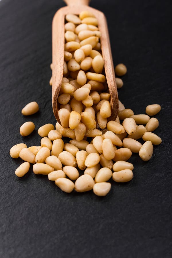 Peeled pine nuts on a rustic background royalty free stock photo