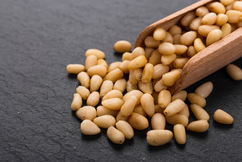 Peeled pine nuts on a rustic background stock photos