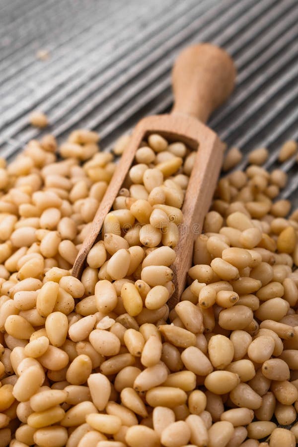 Peeled pine nuts on a rustic background royalty free stock photos