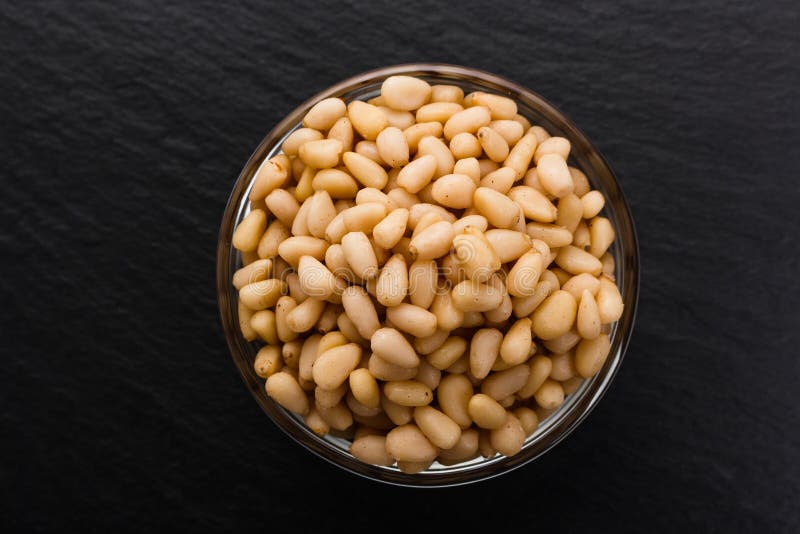 Peeled pine nuts on a rustic background royalty free stock photo