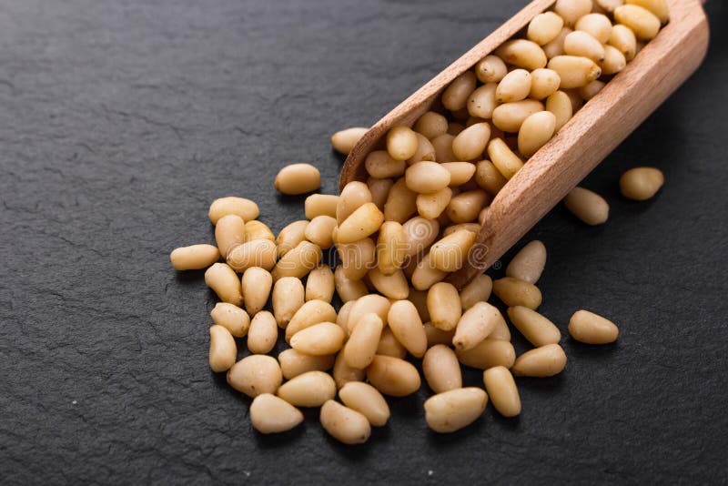 Peeled pine nuts on a rustic background royalty free stock image