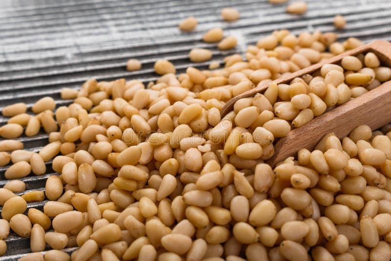 Peeled pine nuts on a rustic background royalty free stock photo
