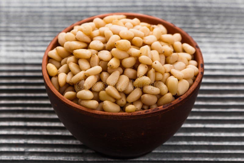 Peeled pine nuts on a rustic background royalty free stock images