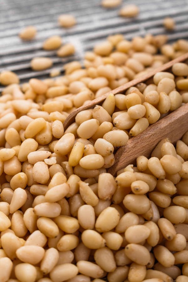 Peeled pine nuts on a rustic background stock photography