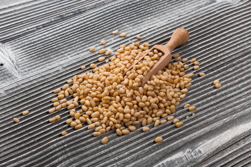Peeled pine nuts on a rustic background stock image
