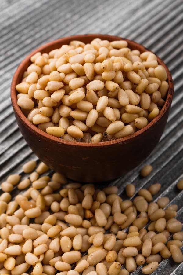 Peeled pine nuts on a rustic background royalty free stock photo