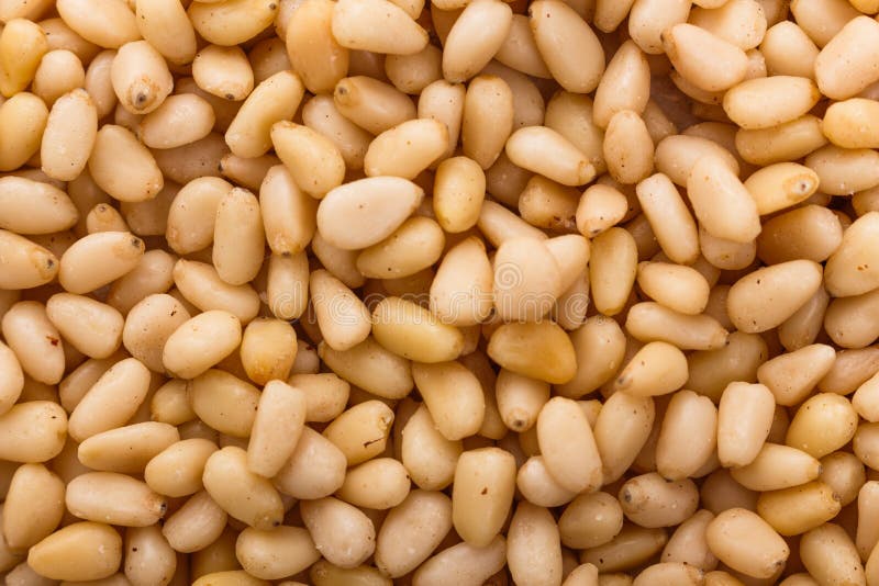 Peeled pine nuts on a rustic background stock photos