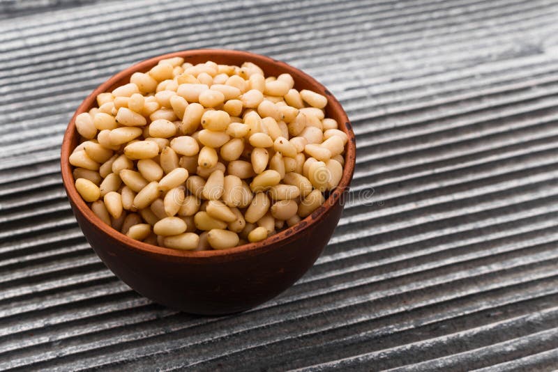 Peeled pine nuts on a rustic background royalty free stock images