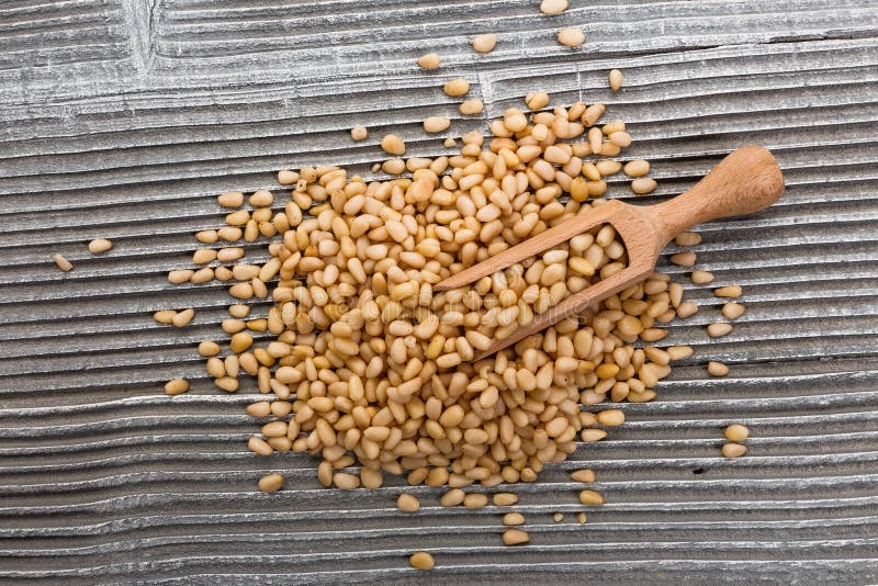 Peeled pine nuts on a rustic background stock photography