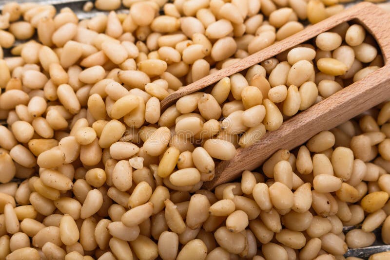 Peeled pine nuts on a rustic background royalty free stock images