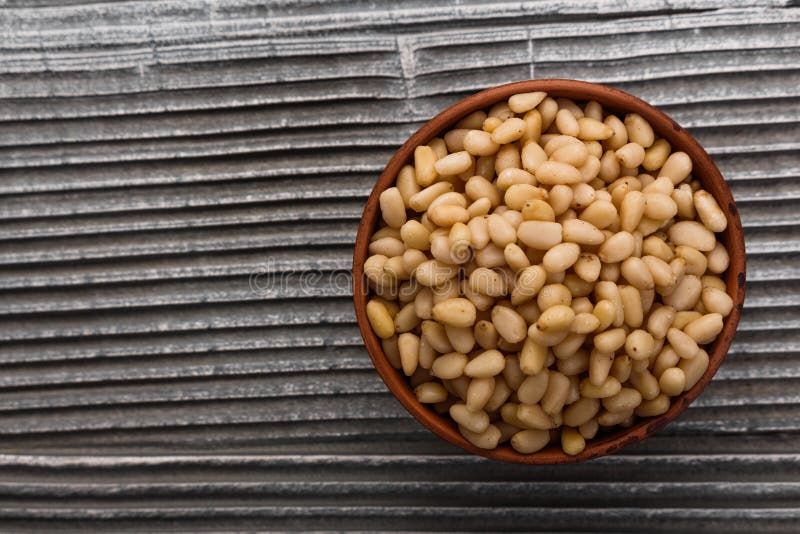 Peeled pine nuts on a rustic background royalty free stock photo