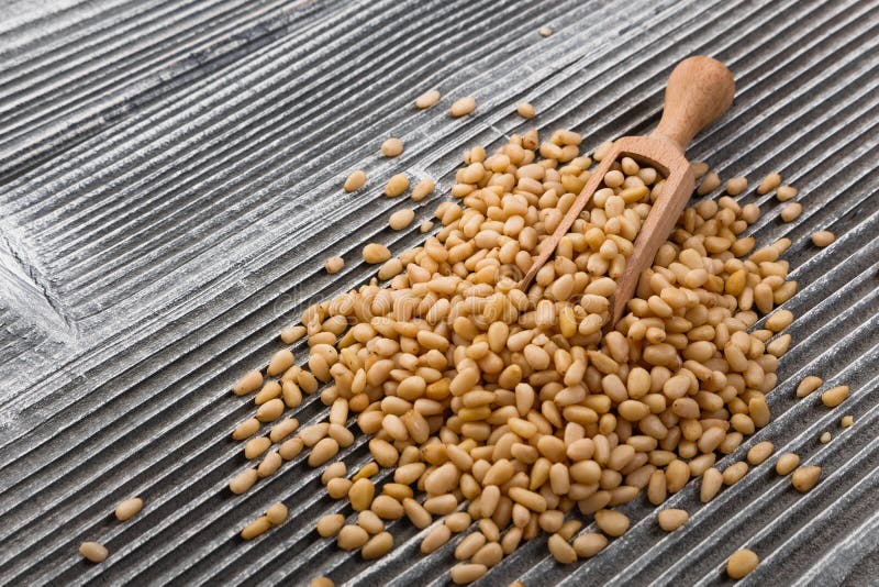 Peeled pine nuts on a rustic background royalty free stock photos