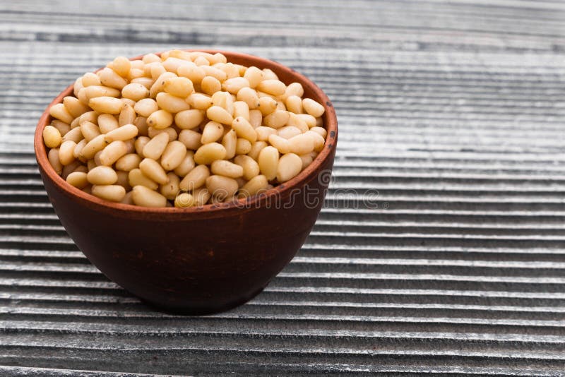 Peeled pine nuts on a rustic background royalty free stock photo