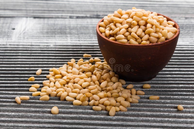 Peeled pine nuts on a rustic background stock photography