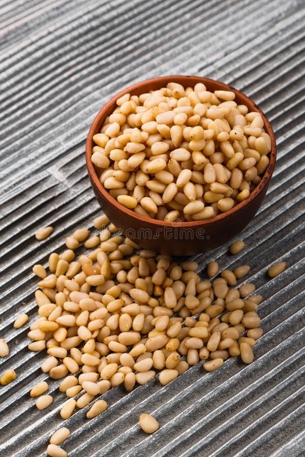 Peeled pine nuts on a rustic background stock photos