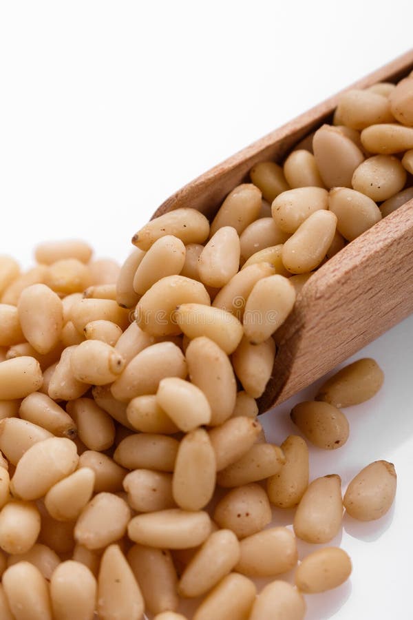 Peeled pine nuts on a white acrylic background royalty free stock photos