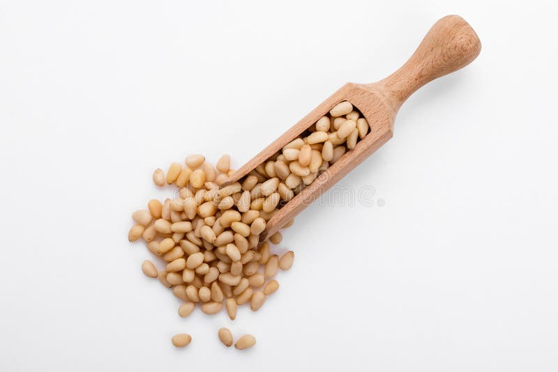 Peeled pine nuts on a white acrylic background royalty free stock image