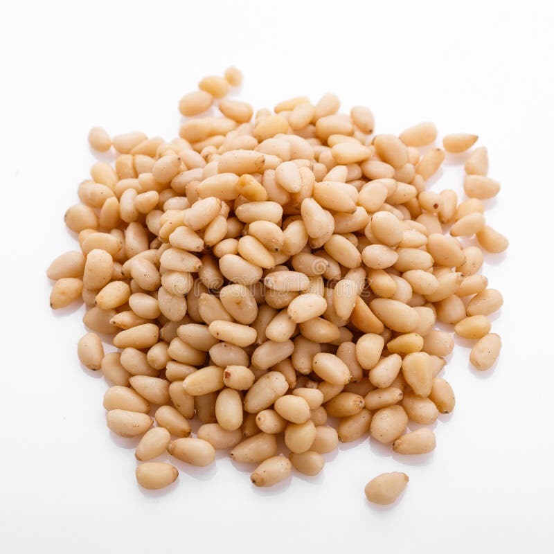 Peeled pine nuts on a white acrylic background royalty free stock photography
