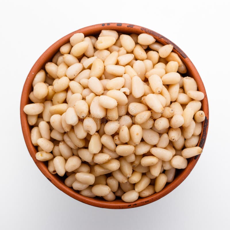 Peeled pine nuts on a white acrylic background royalty free stock image