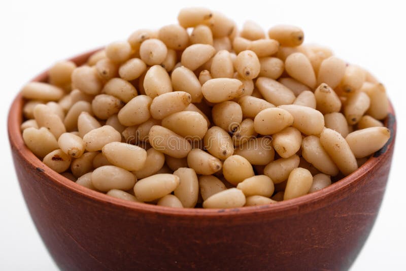 Peeled pine nuts on a white acrylic background royalty free stock images