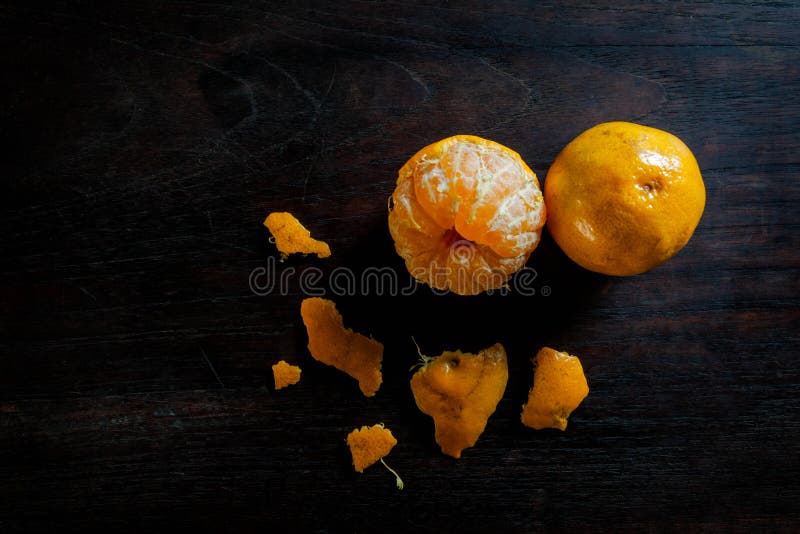 Peeled tangerines on dark wooden table royalty free stock photo Peeled tangerines on dark wooden table royalty free stock photo