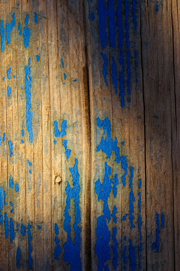 Peeling blue paint on wood