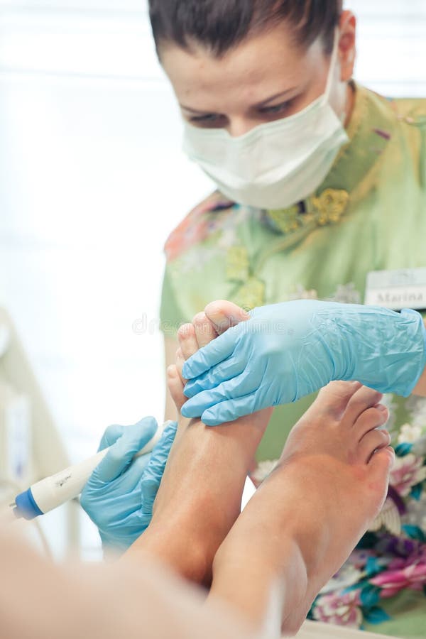 Peeling Feet Pedicure Procedure with Eletric Device in the Beau Stock