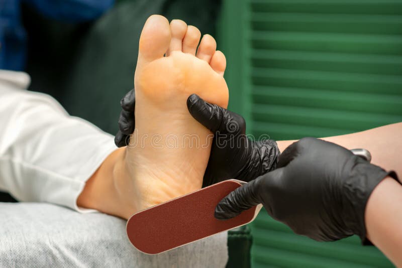 Girl Holding Heels Scraper for Dry Skin on Heels, Pedicure, Foot and Heel  Care, White Background, Chiropody Stock Photo - Image of close, health:  136586892