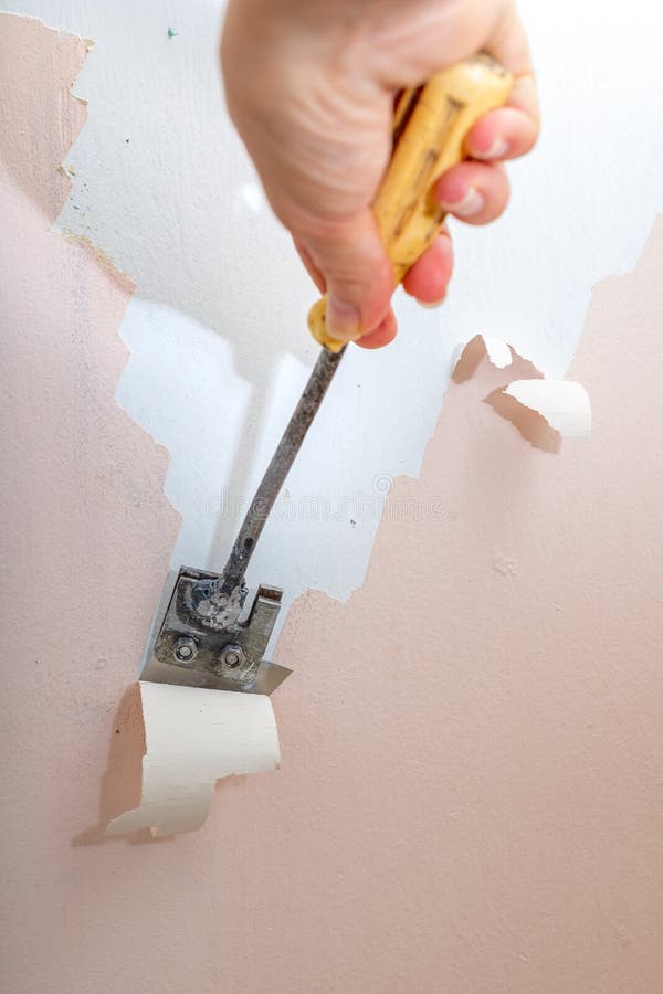 Peeling Old Latex Paint Off the Wall. Using a Scraper To Renovate a
