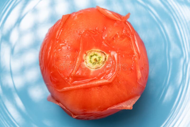 Peeling Tomatoes in Boiling Water. Tomato after Being in Hot Water