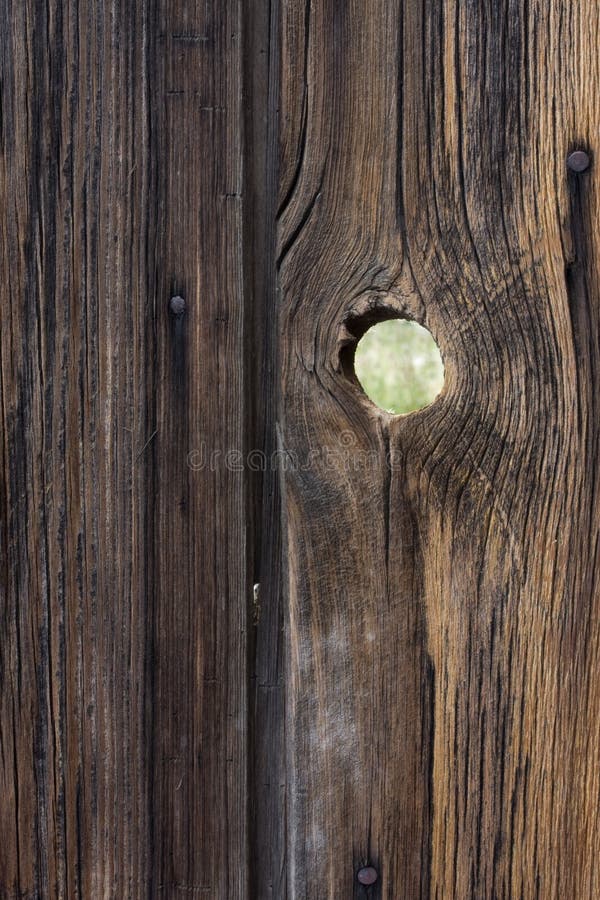 Peephole - weathered wood background with a knotho