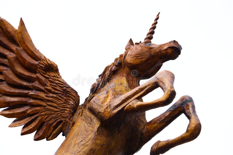 Chainsaw wood carving of a Pegasus Unicorn leaping into flight