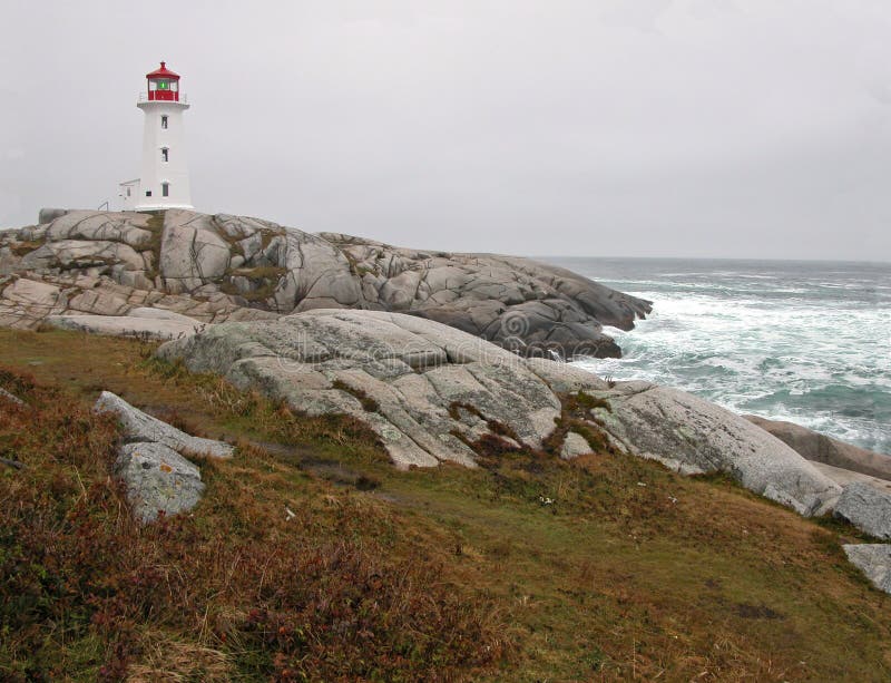 Peggy's Cove Lighthouse perched on granite shores of Atlantic Coast. Famous Nova Scotia lighthouse standing atop Peggy's Point. Peggy's Cove Lighthouse perched on granite shores of Atlantic Coast. Famous Nova Scotia lighthouse standing atop Peggy's Point.