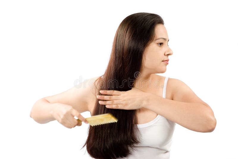 Portrait of beautiful Indian woman combing her long hair. Portrait of beautiful Indian woman combing her long hair