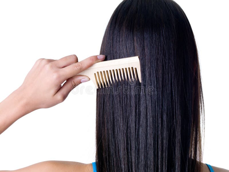 Combing healthy long straight female hair - close-up. Combing healthy long straight female hair - close-up