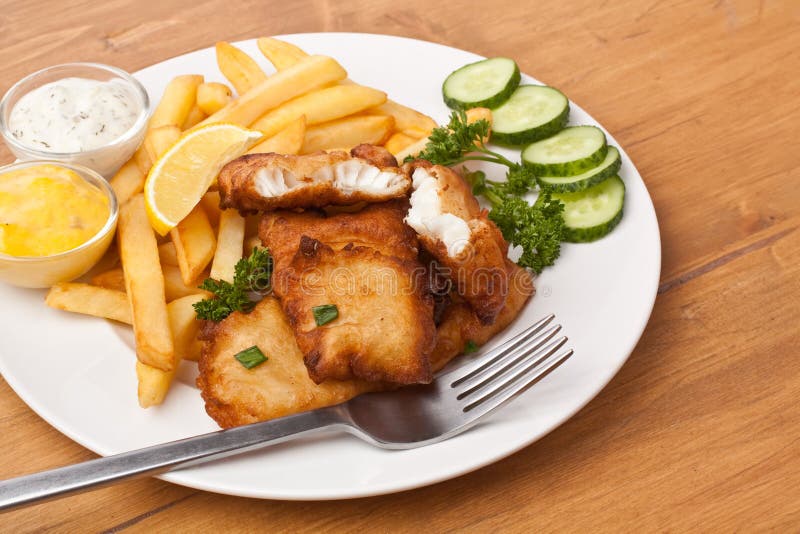 Batted Fish and Chips on a Plate in Wooden Table. Batted Fish and Chips on a Plate in Wooden Table
