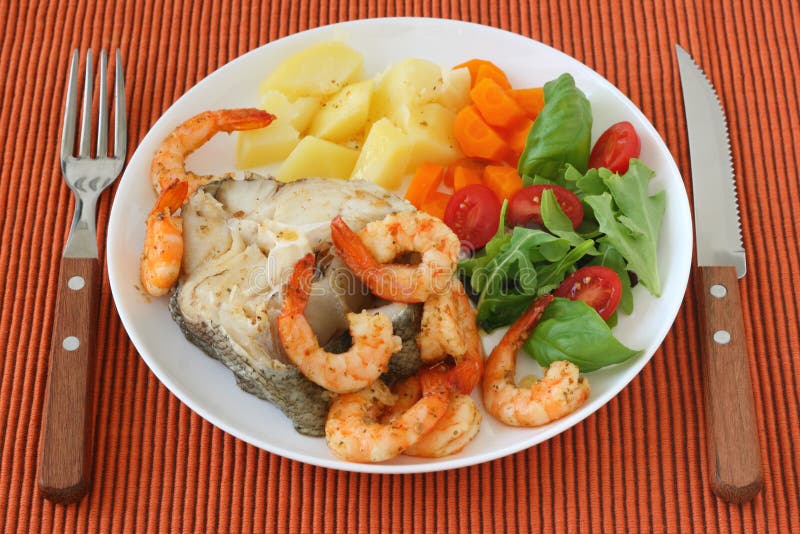 Boiled fish with shrimps, boiled vegetables and salad. Boiled fish with shrimps, boiled vegetables and salad