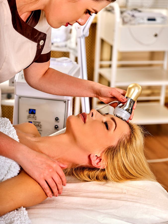 Skin resurfacing facial procedure on ultrasound face machine. Acne treatment for women receiving electric lift massage at spa . Electronic stimulation muscles. Comfort and convenience in beauty salon. Skin resurfacing facial procedure on ultrasound face machine. Acne treatment for women receiving electric lift massage at spa . Electronic stimulation muscles. Comfort and convenience in beauty salon.