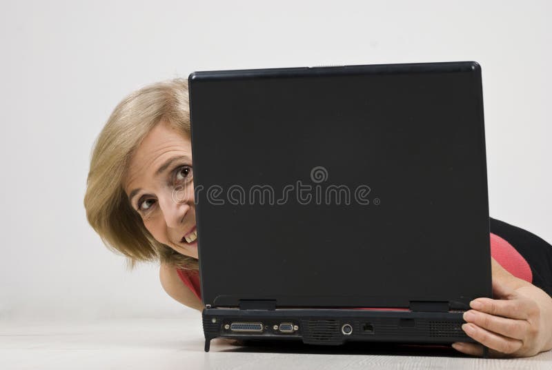 Pellame maturo della donna dietro il computer portatile