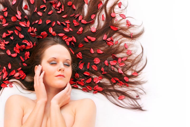 Beautiful young woman with flowers on her long hair. Beautiful young woman with flowers on her long hair