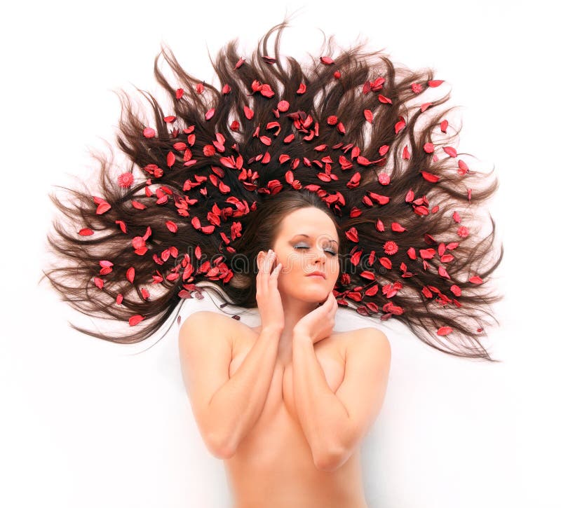 Beautiful young woman with flowers on her long hair. Beautiful young woman with flowers on her long hair.