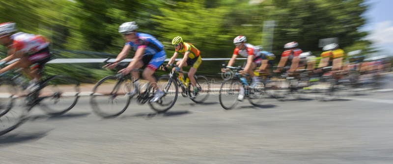 Peloton of bicycle riders in a race in motion